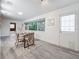 Dining area with a window view, neutral tones and a door to the exterior at 7125 S Shore S Dr, St Petersburg, FL 33707
