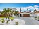 A charming home with a red-tiled roof, tropical plants, and a well-manicured front lawn is displayed in the image at 7125 S Shore S Dr, St Petersburg, FL 33707