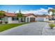 Charming single-story home with a red tile roof, arched entryway, and well-manicured lawn with palm trees at 7125 S Shore S Dr, St Petersburg, FL 33707