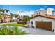 Exterior of a home with brickwork, well maintained lawn, and tropical landscaping, including mature palm trees at 7125 S Shore S Dr, St Petersburg, FL 33707