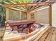 Backyard hot tub with a wooden structure, surrounded by lush greenery, offering a secluded retreat at 7125 S Shore S Dr, St Petersburg, FL 33707