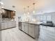 Modern kitchen with large island, stainless steel appliances, and view to the living area at 7125 S Shore S Dr, St Petersburg, FL 33707
