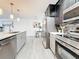 Well-lit kitchen with stainless steel appliances, island, and open layout at 7125 S Shore S Dr, St Petersburg, FL 33707