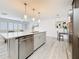 Spacious kitchen island with stainless steel dishwasher and adjacent living area at 7125 S Shore S Dr, St Petersburg, FL 33707