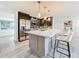Open concept kitchen with stainless steel appliances, island with seating, and ample counter space at 7125 S Shore S Dr, St Petersburg, FL 33707