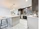 Modern kitchen featuring an island, stainless steel appliances, and stylish backsplash at 7125 S Shore S Dr, St Petersburg, FL 33707