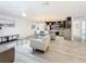 Bright, open-concept living room and kitchen with modern finishes and light wood-look floors at 7125 S Shore S Dr, St Petersburg, FL 33707