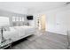 The main bedroom is bright, features wood-look floors, a ceiling fan, and a TV at 7125 S Shore S Dr, St Petersburg, FL 33707