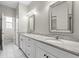 Bright bathroom featuring a dual vanity with white cabinets and granite countertops at 807 Callista Cay Loop, Tarpon Springs, FL 34689