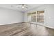 Spacious bedroom with wood flooring and sliding glass doors leading to a balcony at 807 Callista Cay Loop, Tarpon Springs, FL 34689