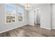 Dining room with natural light and wood flooring, showcasing an elegant chandelier at 807 Callista Cay Loop, Tarpon Springs, FL 34689
