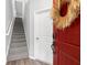 Modern foyer with a striking red door featuring a smart lock and stairs leading to the upper level at 807 Callista Cay Loop, Tarpon Springs, FL 34689