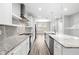Modern kitchen featuring stainless steel appliances, granite countertops, and stylish backsplash at 807 Callista Cay Loop, Tarpon Springs, FL 34689
