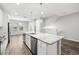 Bright kitchen featuring a large island with a sink, stainless steel appliances, and pendant lighting at 807 Callista Cay Loop, Tarpon Springs, FL 34689