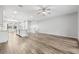 Open concept living room with wood-look floors, recessed lighting, ceiling fan, and an adjacent kitchen space at 807 Callista Cay Loop, Tarpon Springs, FL 34689