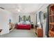 This bedroom features a bed, dresser, curtains, and ceiling fan, offering a comfortable and relaxing atmosphere at 953 Tropical Nw Ave, Port Charlotte, FL 33948