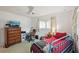 This bedroom has a blue metal bed frame, a ceiling fan, and a wooden dresser with a television at 953 Tropical Nw Ave, Port Charlotte, FL 33948