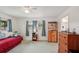 This bedroom features a bed, dresser, curtains, and ceiling fan, offering a comfortable and relaxing atmosphere at 953 Tropical Nw Ave, Port Charlotte, FL 33948