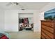 A walk-in closet features an array of clothes hanging, and various shoes, containers, and boxes on the floor at 953 Tropical Nw Ave, Port Charlotte, FL 33948