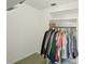 This is a closet filled with lots of clothes on hangers and a shelf on top, perfect for organization at 953 Tropical Nw Ave, Port Charlotte, FL 33948