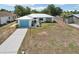 Charming single-story home with a blue garage door, decorative seahorse accent, and a well-maintained lawn at 953 Tropical Nw Ave, Port Charlotte, FL 33948