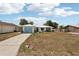 Charming single Gathering home featuring a light blue garage door and a well-maintained lawn at 953 Tropical Nw Ave, Port Charlotte, FL 33948