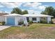 Charming single Gathering home with light blue garage door and tasteful exterior details at 953 Tropical Nw Ave, Port Charlotte, FL 33948