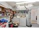 Bright laundry room features a washer, dryer, water heater, shelving and storage for optimal organization at 953 Tropical Nw Ave, Port Charlotte, FL 33948