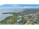 An aerial view of real estate featuring waterfront condos surrounded by lush greenery and mature trees at 965 S Florida Ave, Tarpon Springs, FL 34689