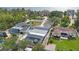 An aerial view shows a home with a screened in pool and waterfront access with lush landscaping at 965 S Florida Ave, Tarpon Springs, FL 34689