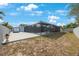 Spacious backyard features a screened-in pool, patio area, and partial fencing at 965 S Florida Ave, Tarpon Springs, FL 34689