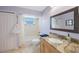Bathroom with a large mirror, tiled floors, and granite countertops at 965 S Florida Ave, Tarpon Springs, FL 34689