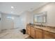 Bathroom features granite countertops, a modern mirror, and tile flooring at 965 S Florida Ave, Tarpon Springs, FL 34689