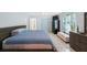 Well-lit bedroom featuring a modern bed, tiled floors, and large windows at 965 S Florida Ave, Tarpon Springs, FL 34689