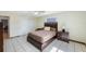 Bedroom with tiled flooring, wood furniture, and light green walls at 965 S Florida Ave, Tarpon Springs, FL 34689