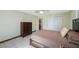 Bedroom with white tiled floor, dark wood furniture, and sliding door closet at 965 S Florida Ave, Tarpon Springs, FL 34689