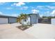 Well-kept single-Gathering home featuring a two-car garage, a nicely landscaped yard, and a privacy gate at 965 S Florida Ave, Tarpon Springs, FL 34689