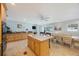 Bright open kitchen with stainless appliances, granite countertops, and a central island with breakfast bar seating at 965 S Florida Ave, Tarpon Springs, FL 34689