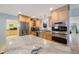 Modern kitchen with stainless steel appliances, granite countertops, and light wood cabinets at 965 S Florida Ave, Tarpon Springs, FL 34689