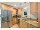 Modern kitchen featuring stainless steel appliances, a large sink, and wooden cabinetry at 965 S Florida Ave, Tarpon Springs, FL 34689
