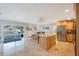 Open kitchen and dining area with marble floors, pool view, and stainless steel appliances at 965 S Florida Ave, Tarpon Springs, FL 34689