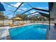 Relaxing screened pool area featuring comfortable lounge furniture and clear blue water at 965 S Florida Ave, Tarpon Springs, FL 34689