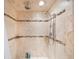 Luxurious shower with natural stone, dual showerheads and mosaic accents at 965 S Florida Ave, Tarpon Springs, FL 34689
