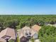 Aerial view of the home showcasing the roof, trees, and surrounding neighborhood at 9709 Bay Colony Dr, Riverview, FL 33578