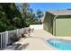 Backyard view with mature landscaping, fencing, and the in-ground pool at 9709 Bay Colony Dr, Riverview, FL 33578