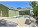 Backyard features an in-ground pool, bench, and mature landscaping at 9709 Bay Colony Dr, Riverview, FL 33578
