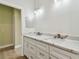 Bright bathroom with a double sink vanity, modern fixtures, and sleek hardware at 9709 Bay Colony Dr, Riverview, FL 33578
