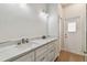 Bathroom with a double sink vanity, modern fixtures, and white cabinets at 9709 Bay Colony Dr, Riverview, FL 33578