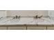 Bathroom close-up of double sink vanity featuring marble-look countertop at 9709 Bay Colony Dr, Riverview, FL 33578