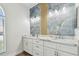 Bathroom features double vanity with marble countertop and decorative accent wall at 9709 Bay Colony Dr, Riverview, FL 33578